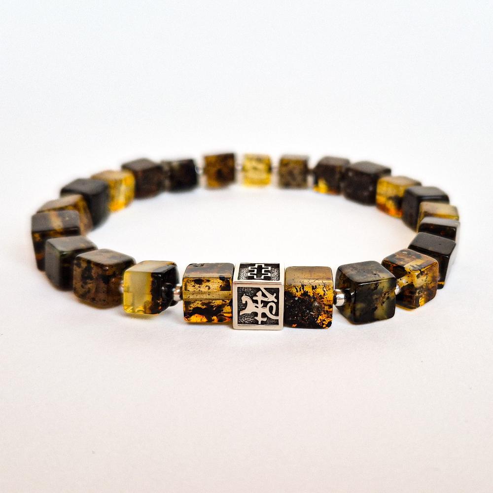 A bracelet featuring polished Baltic amber beads and a handcrafted silver charm with the 'Vytis' symbol.
