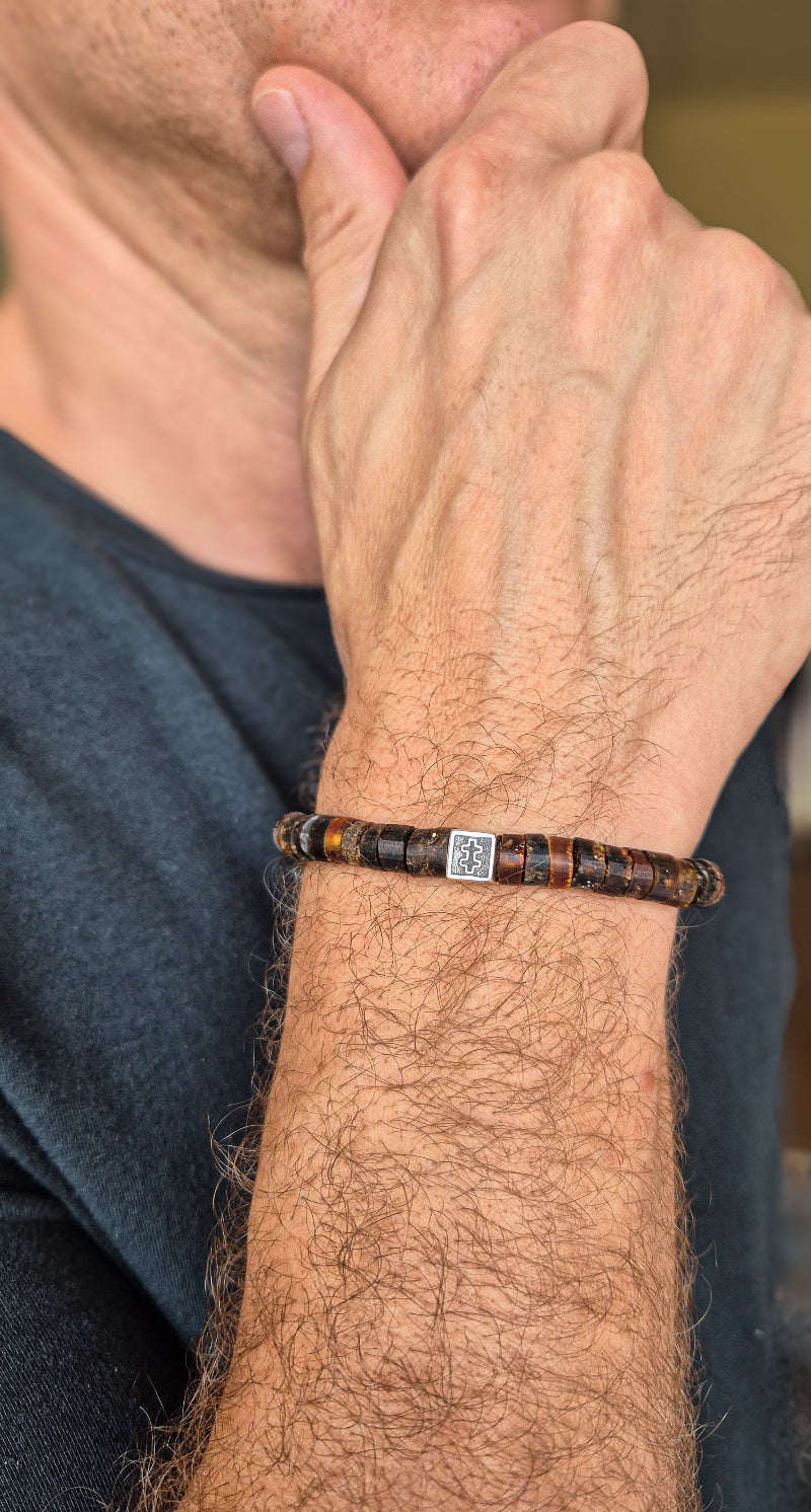 Close-up of a person wearing a bracelet on their wrist.