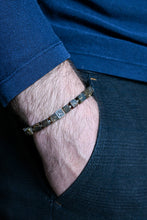 Load image into Gallery viewer, Close-up of a wrist wearing a bracelet with a blue shirt and dark pants.