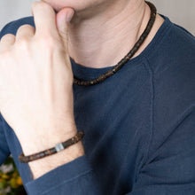 Load image into Gallery viewer, Person wearing a dark blue shirt with a beaded bracelet on their wrist.