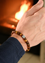 Load image into Gallery viewer, Hand wearing a beaded Baltic amber mens bracelet 