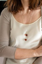 Load image into Gallery viewer, Person wearing a white satin top and a necklace with three round pendants.