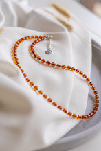 Load image into Gallery viewer, Beaded amber necklace on a white fabric background