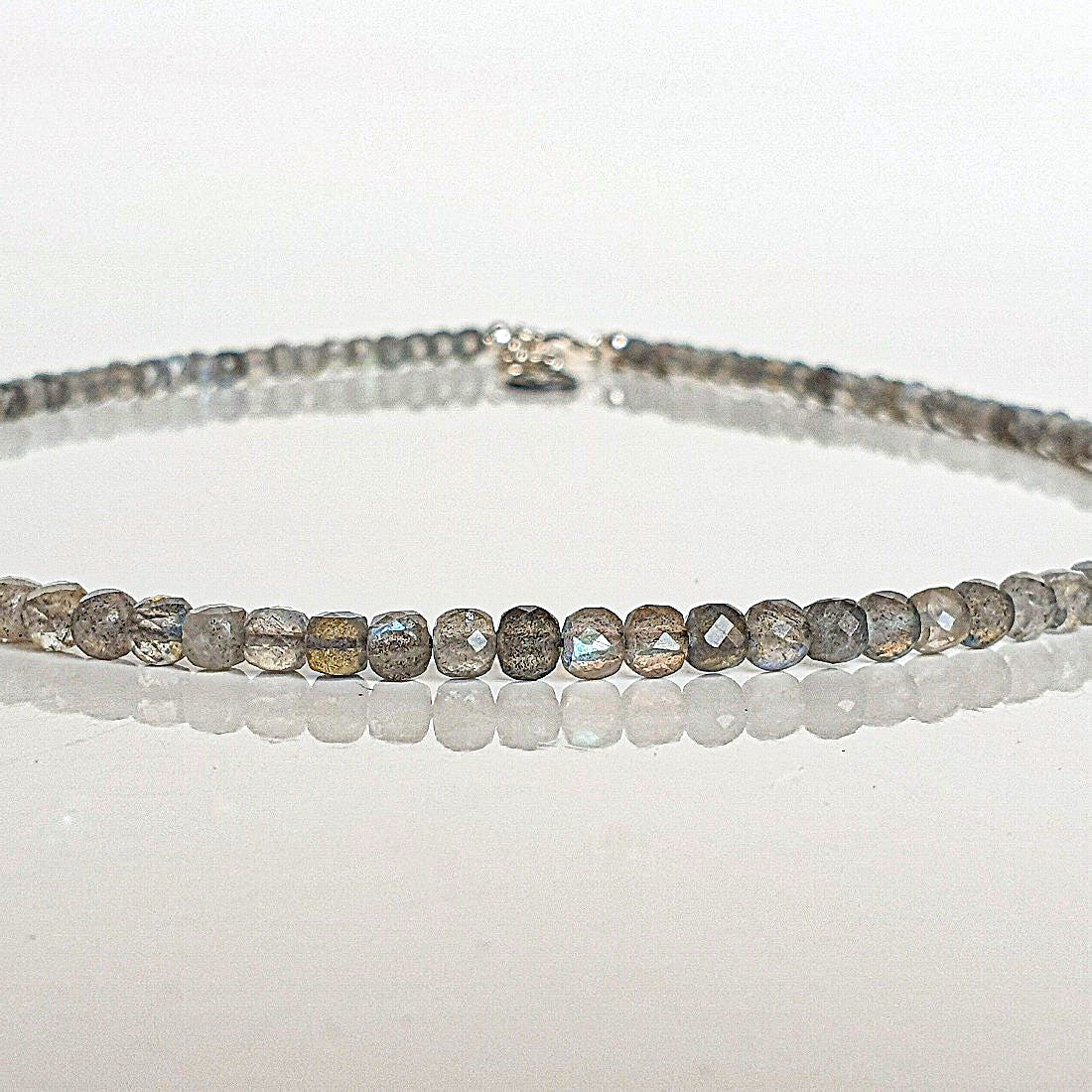beaded necklace on a white surface
